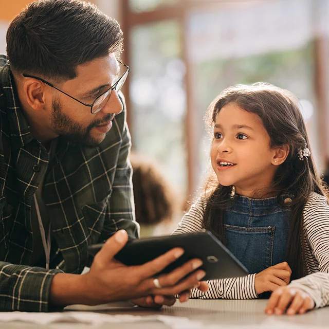 Teacher and student looking at a tablet.