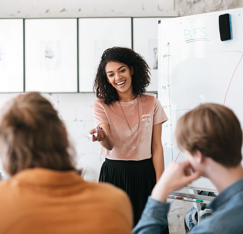 Woman presenting data to colleagues.