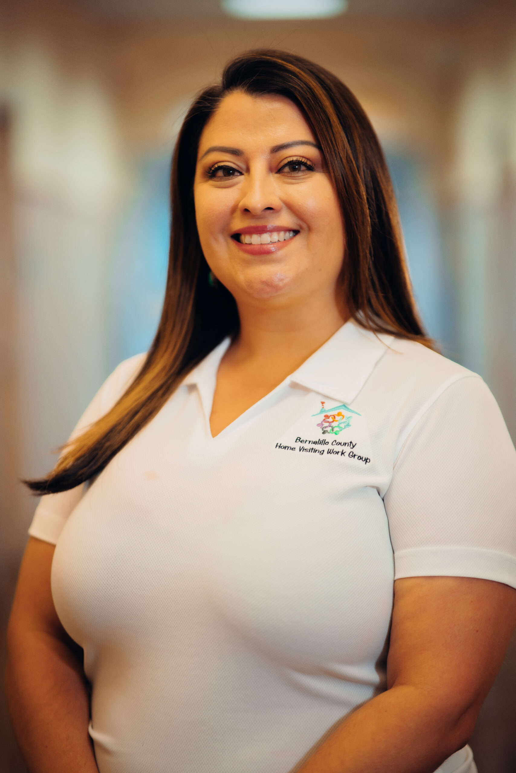 Smiling woman wearing a white shirt.